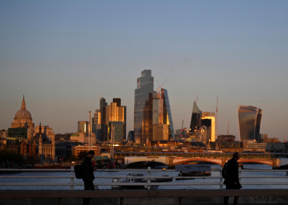 People cross Waterloo Bridge in London. The UK economy shrank in August