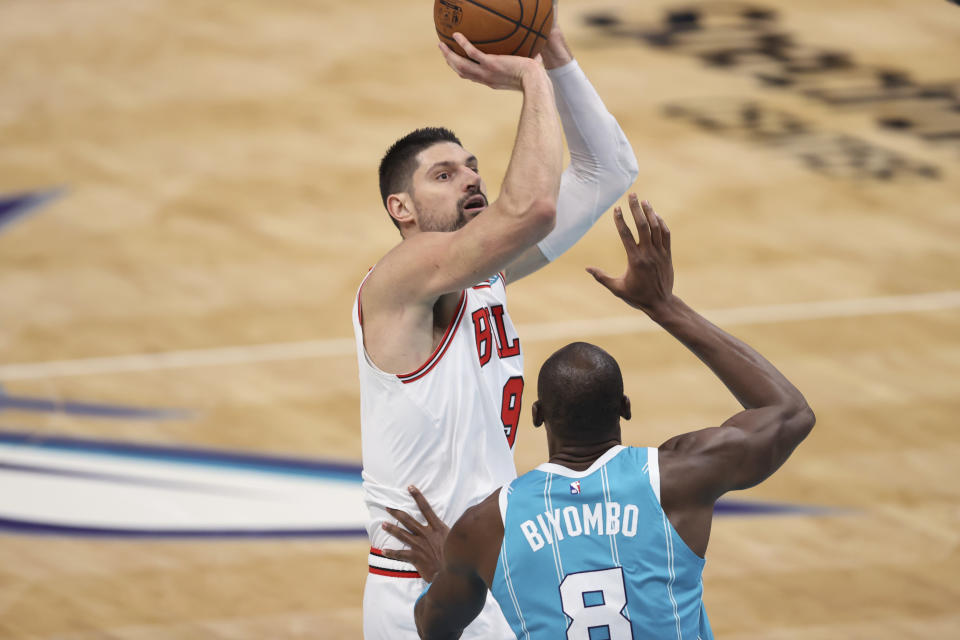 Chicago Bulls center Nikola Vucevic shoots over Charlotte Hornets center Bismack Biyombo during the second half of an NBA basketball game in Charlotte, N.C., Thursday, May 6, 2021. (AP Photo/Nell Redmond)