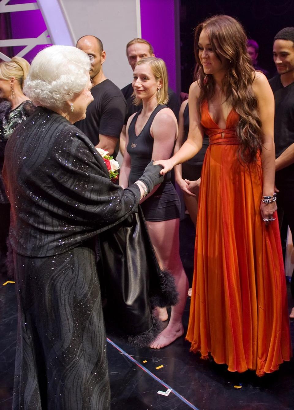 <p>I’m not sure what Queen Elizabeth would think of Miley’s fashion choices today, but back in 2009, she seemed to approve of the star’s burnt orange gown.</p>