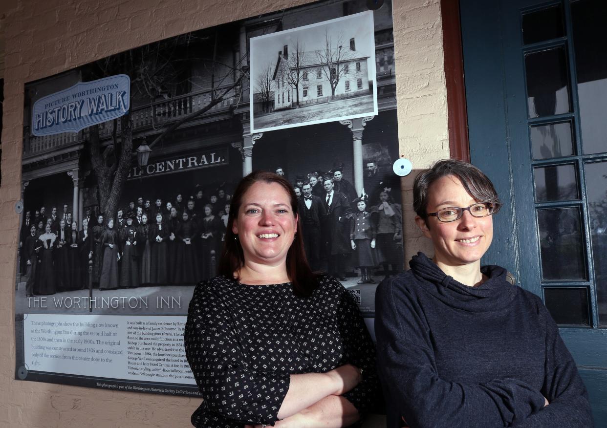 Kate LaLonde, director or the Worthington Historical Society, and Meredith Southard, librarian with the Worthington Libraries, present the history walk poster at the Worthington Inn.  The inn is one of 15 stops along the history walk that is to go through the end of June.