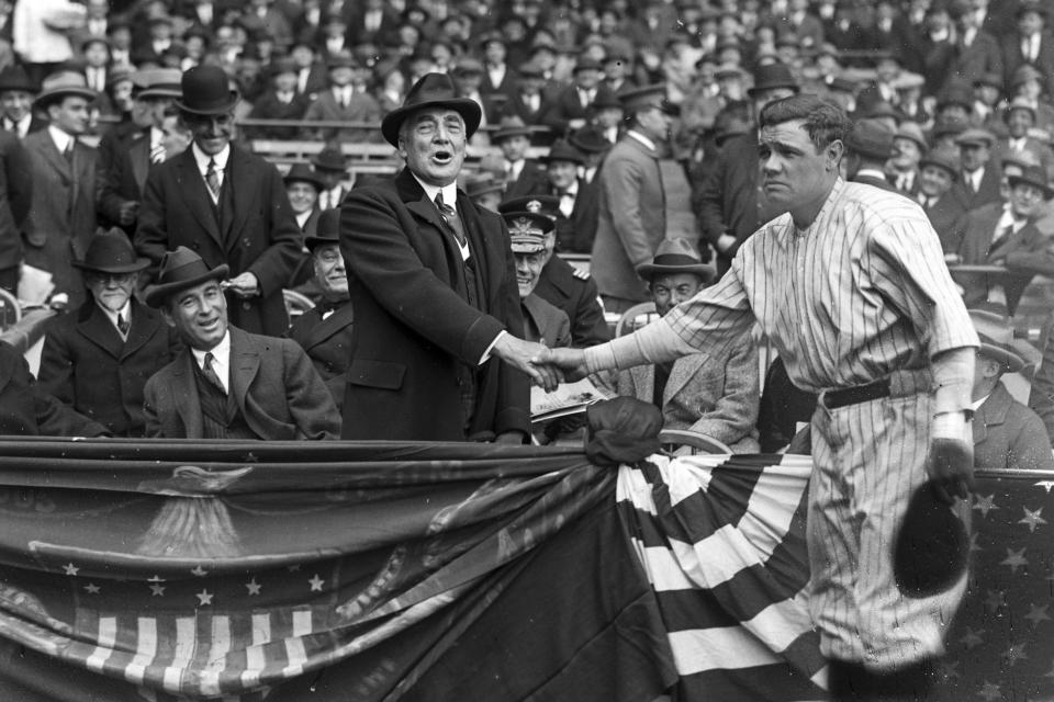 This photo provided by the Library of Congress, dated April 24, 1923, shows New York Yankees Babe Ruth, right, shaking hands with President Warren Harding, at New York's Yankee Stadium. The 100th anniversary of the original Yankee Stadium is marked Tuesday, April 18, 2023, a ballpark that revolutionized baseball with its grandeur and the success of the team. (Library of Congress via AP)