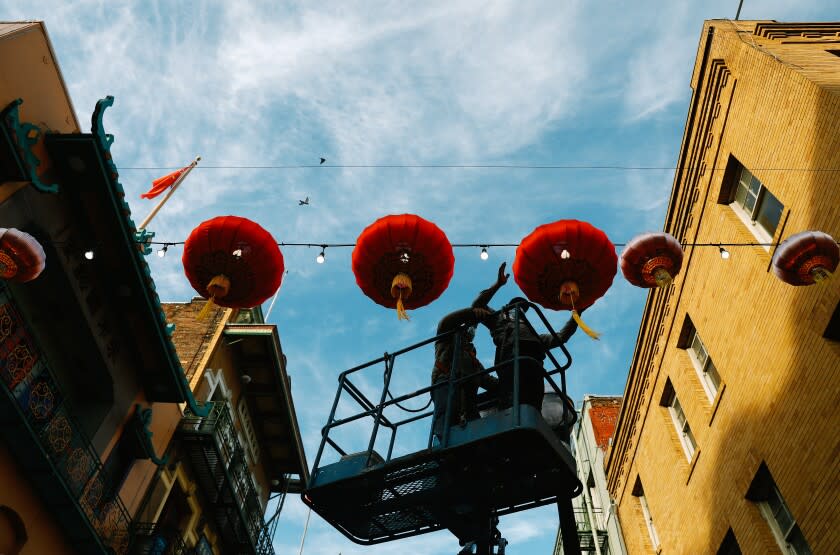 SAN FRANCISCO-CA-JANUARY 14, 2022: Old lanterns are replaced with new, larger ones in San Francisco's Chinatown on Wednesday, January 14, 2022. (Christina House / Los Angeles Times)