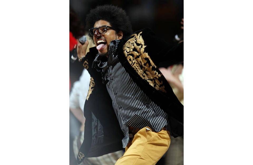 FILE - In this Feb. 25, 2008, file photo, Greg "Shock G" Jacobs, leader for Digital Underground, performs The Humpty Dance during a halftime appearance in the Detroit Pistons' NBA basketball game against the Denver Nuggets in Denver. Shock G, who blended whimsical wordplay with reverence for '70s funk as leader of the off-kilter hip-hop group Digital Underground, has died. He was 57. Nzazi Malonga, a longtime friend who served as head of security and helped manage the group, said the rapper-producer was found unresponsive Thursday, April 22, 2021, in a hotel room in Tampa, Fla. (AP Photo/David Zalubowski, File)