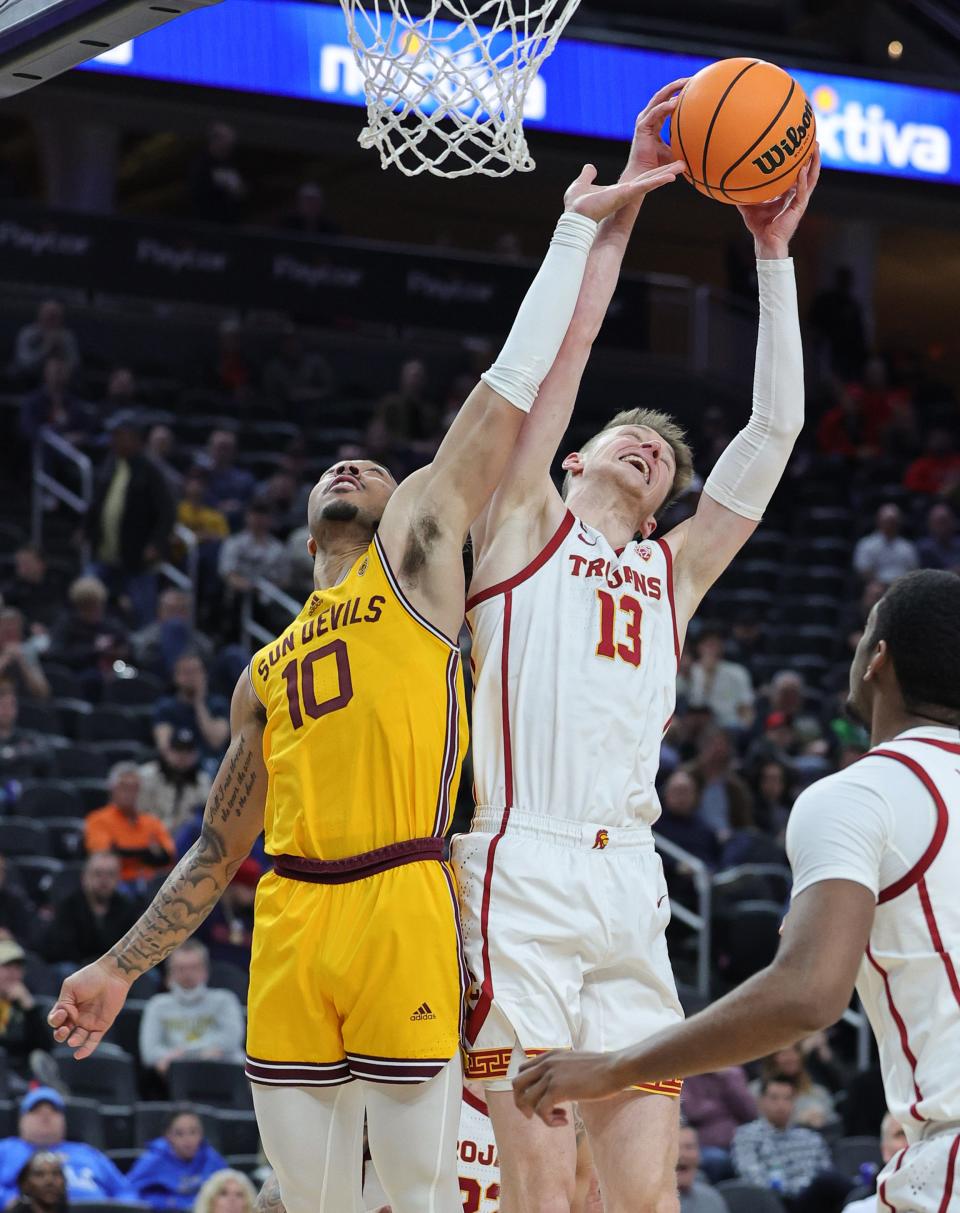 Drew Peterson #13 of the USC Trojans grabs a rebound against Frankie Collins #10 of the Arizona State Sun Devils in the second half of a quarterfinal game of the Pac-12 basketball tournament at T-Mobile Arena on March 9, 2023, in Las Vegas, Nevada. The Sun Devils defeated the Trojans 77-72.