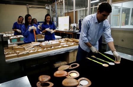 Workers from the Casa da Moeda do Brasil (Brazilian Mint) prepare the Rio 2016 Olympic and Paralympic medals in Rio de Janeiro, Brazil, June 28, 2016. REUTERS/Sergio Moraes