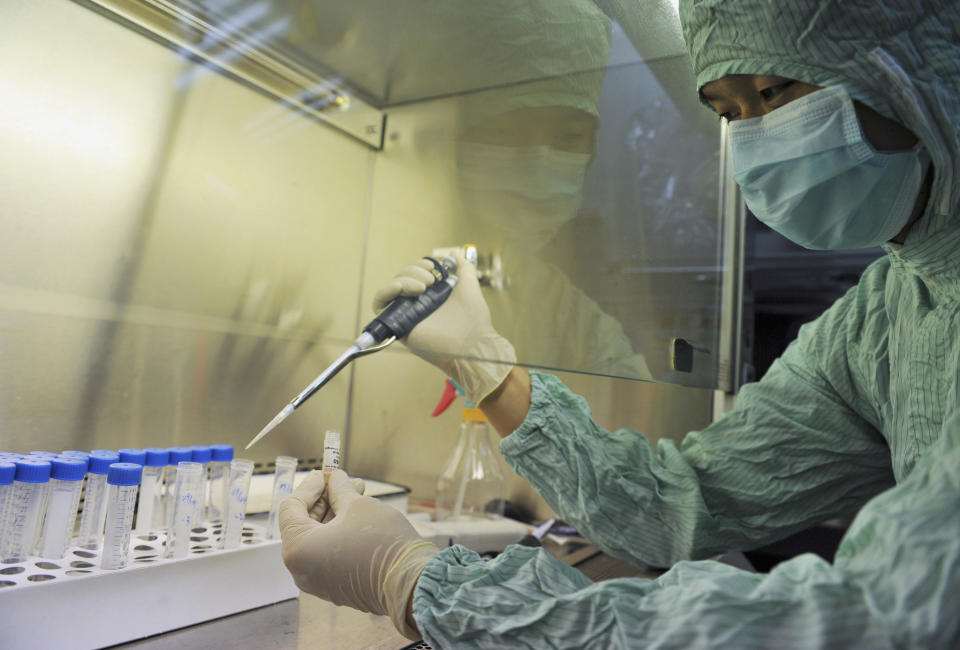 A technician works to produce vaccines