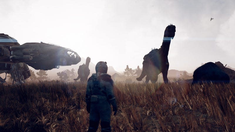 Strange dinosaur-like aliens walk in the background as an astronaut watches them from the foreground.