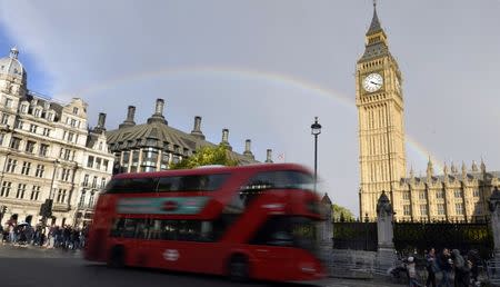 A rainbow is seen behind the Big Ben clock tower, at the Houses of Parliament in central London, Britain, October 16, 2016. REUTERS/Hannah McKay