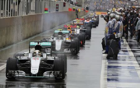 Formula One - F1 - Brazilian Grand Prix - Circuit of Interlagos, Sao Paulo, Brazil - 13/11/2016 - Mercedes' Lewis Hamilton of Britain (44) leads other cars in the pit area during a pause in racing due to heavy rainfall. REUTERS/Paulo Whitaker