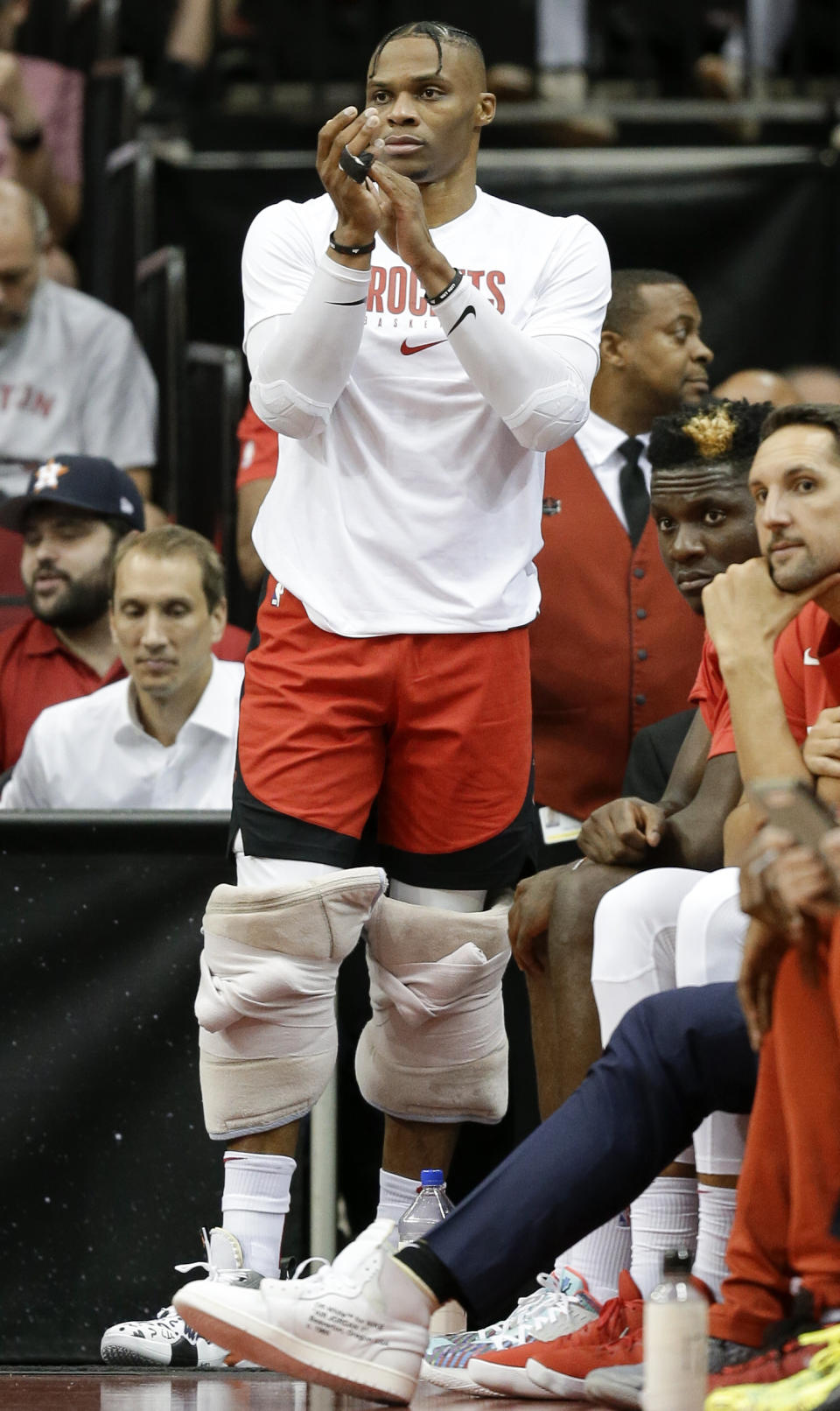 Houston Rockets guard Russell Westbrook watches from the bench area during the first half of the team's NBA basketball game against the Milwaukee Bucks, Thursday, Oct. 24, 2019, in Houston. (AP Photo/Eric Christian Smith)