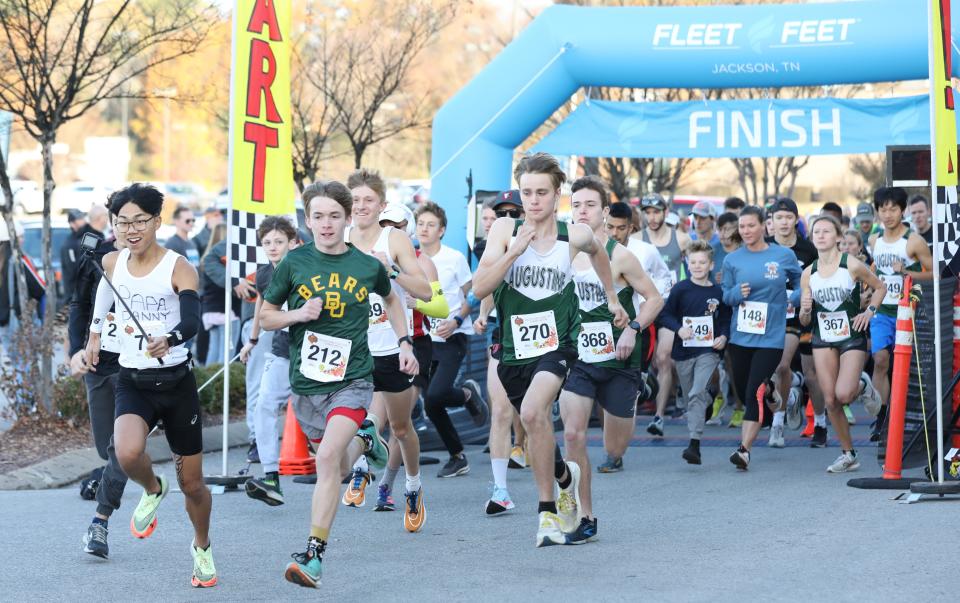 Danny Phan, Kaden Mosley, and Nathan Smith led the way at the beginning of the 18th Annual Turkey Day 5K sponsored by Gold's Gym and Fleet Feet on Thursday, November 24, 2022, in Jackson, Tennessee.  Over 600 runners participate in the event each year which is held to benefit the Regional Inter-faith Association (RIFA).