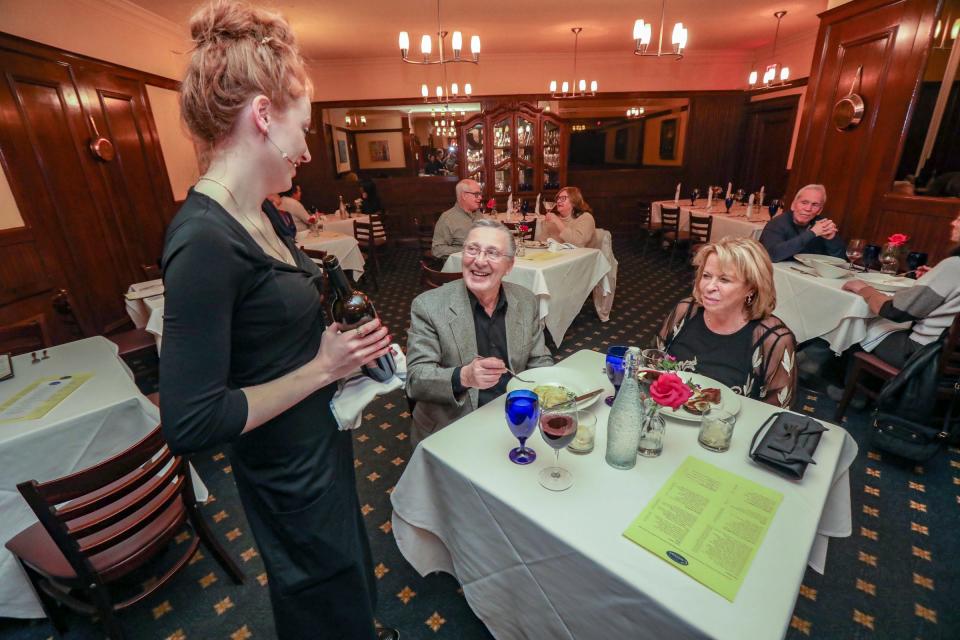 Server Allison Blair greets patrons Lou and Julie Aronica, of Waterford Township at Cuisine. Julie Aronica says she always has dinner at the restaurant before shows at the Fisher.