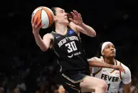 New York Liberty forward Breanna Stewart (30) goes to the basket past Indiana Fever forward NaLyssa Smith (1) during the second half of a WNBA basketball game, Saturday, May 18, 2024, in New York. The New York Liberty won 91-80. (AP Photo/Noah K. Murray)