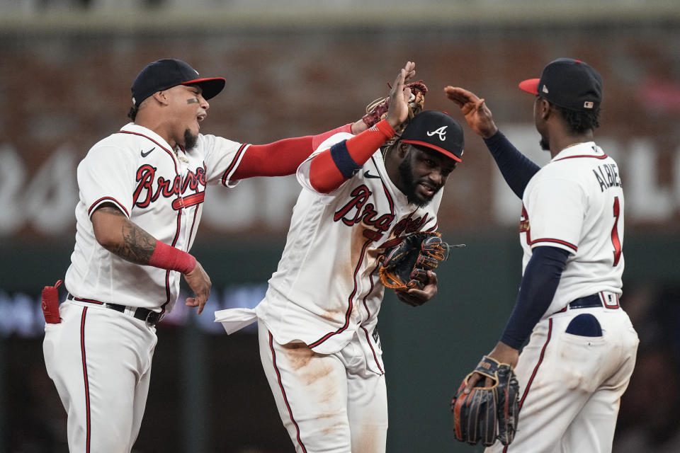 Atlanta Braves center fielder Michael Harris II, center, celebrates with teammates Orlando Arcia, left, and Ozzie Albies after defeating the New York Mets in a baseball game, Wednesday, June 7, 2023, in Atlanta. (AP Photo/John Bazemore)