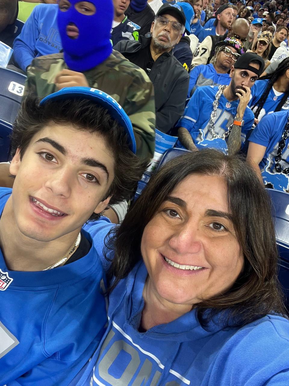 Joshua Paxton, left, and his mother, Vera, pose for a selfie during a Lions game at Ford Field.