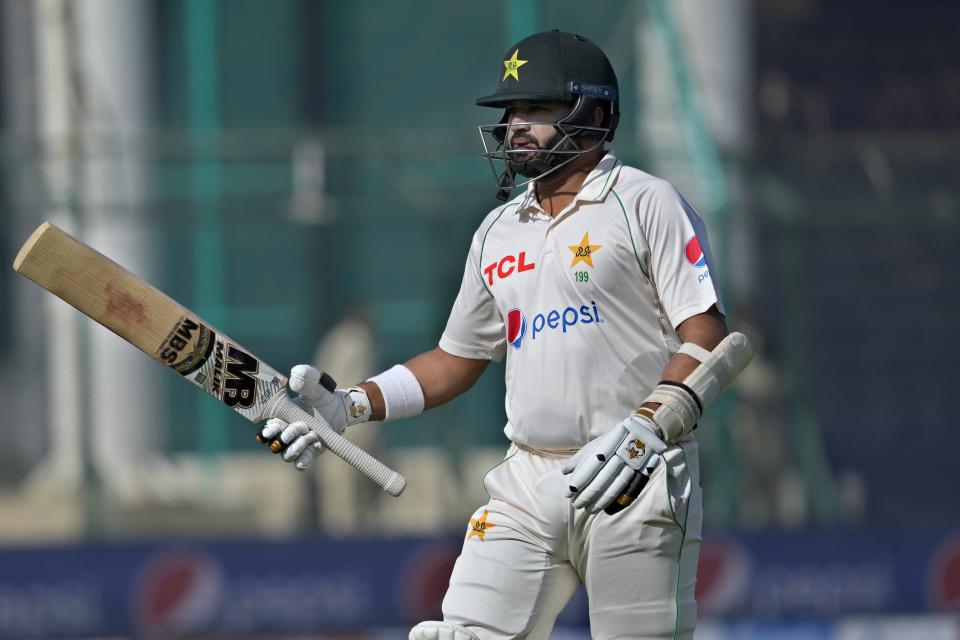Pakistan's Azhar Ali, who is playing his last match due to his retirement, reacts as he walks off the field after his dismissal during the third day of third test cricket match between England and Pakistan, in Karachi, Pakistan, Monday, Dec. 19, 2022. (AP Photo/Fareed Khan)