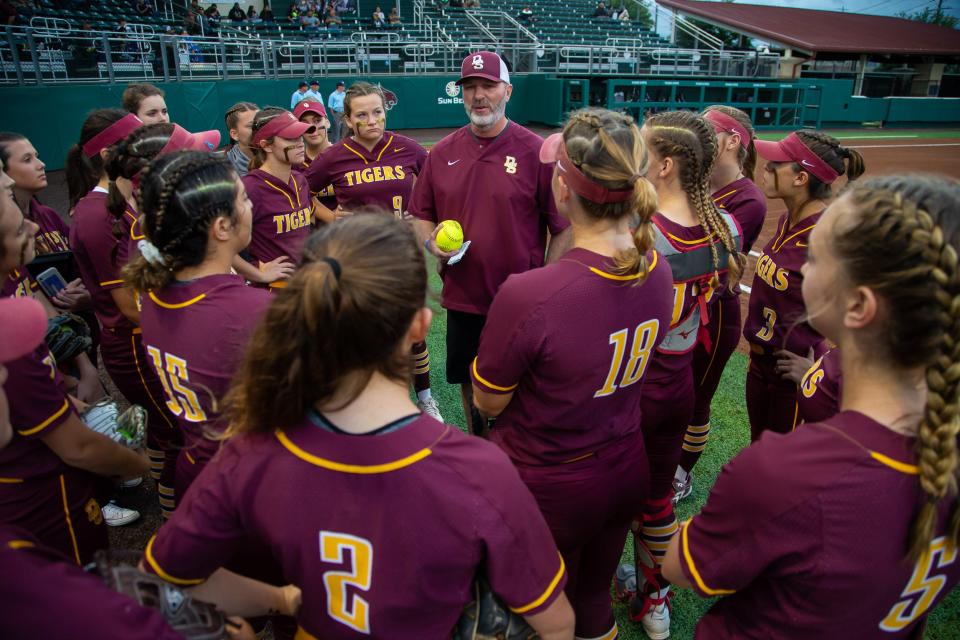 Dripping Springs head softball coach Wade Womack, shown talking to his team before a 2019 playoff game, has guided his Tigers to the District 26-6A co-championship and its No. 1 playoff seed in the school's first season as a Class 6A program. The Tigers beat Johnson 3-2 Monday night to determine playoff seeding.