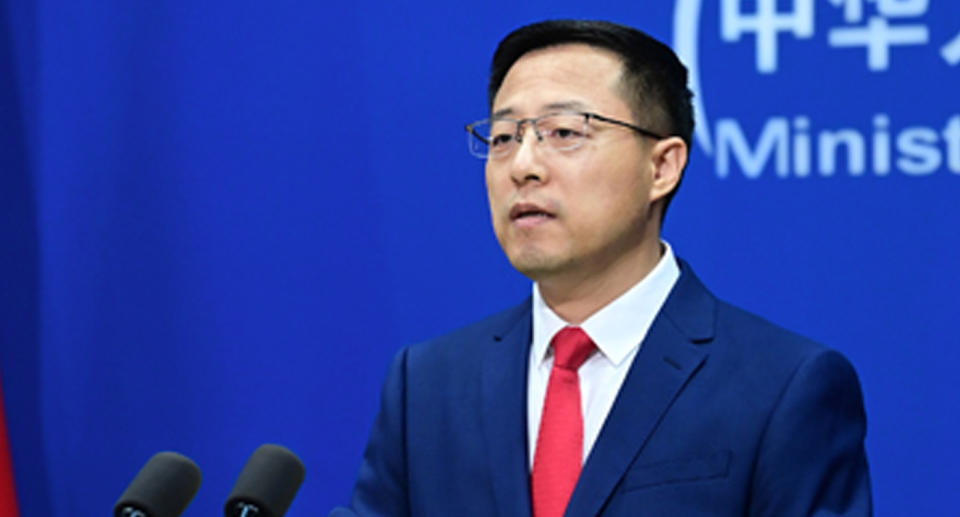 China’s Foreign Ministry spokesperson Zhao Lijian in a blue suit and red tie.