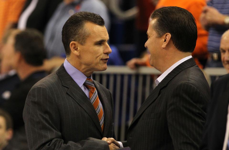 In this file photo from Feb. 12, 2013, then-Florida coach Billy Donovan shakes hands with then-Kentucky coach John Calipari before a game at the O'Connell Center in Gainesville, Florida.