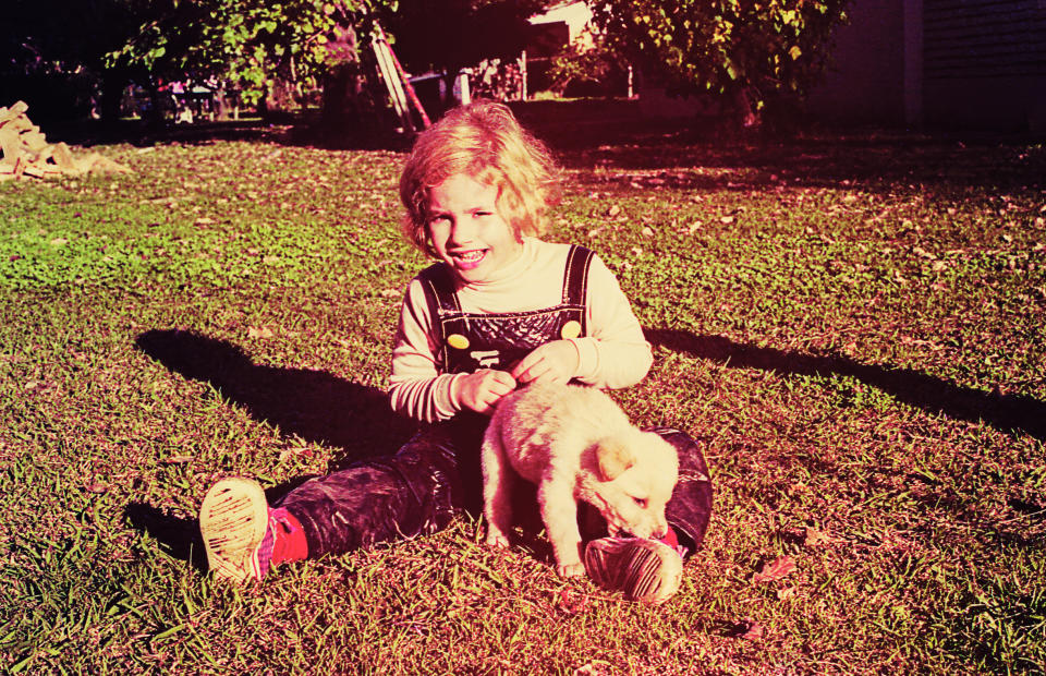 a kid playing with their puppy