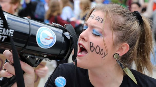 PHOTO: Allison Bucy yells into a bullhorn during the 2022 Women's March with the theme 'We Demand Our Rights' in anticipation of the upcoming U.S. midterm elections on Capitol Hill in Washington, Oct. 8, 2022. (Amanda Andrade-rhoades/Reuters)