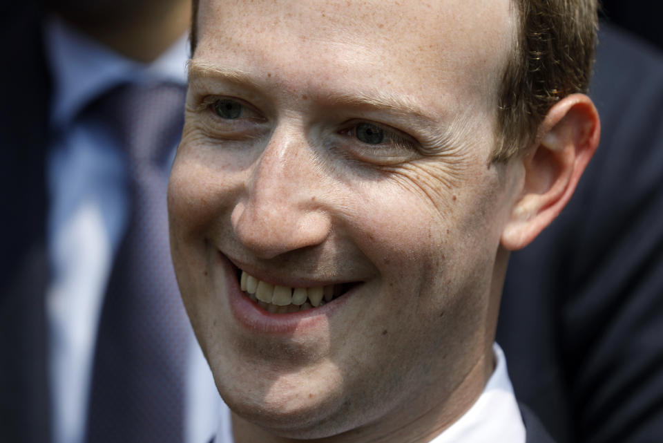 FILE - In this May 23, 2018 file phpoto, Facebook's CEO Mark Zuckerberg smiles during a picture with guests attending the "Tech for Good" Summit at the Elysee Palace in Paris. Zuckerberg’s latest attempt to explain Facebook’s data-sharing practices is notable for its omissions as well as what it plays up and plays down. In a Wall Street Journal op-ed Thursday, Jan. 24, 2019, titled “The Facts About Facebook,” the CEO doubles down on previous talking points while leaving out, for example, a Federal Trade Commission investigation over its privacy practices.  (Charles Platiau/Pool Photo via AP, File)