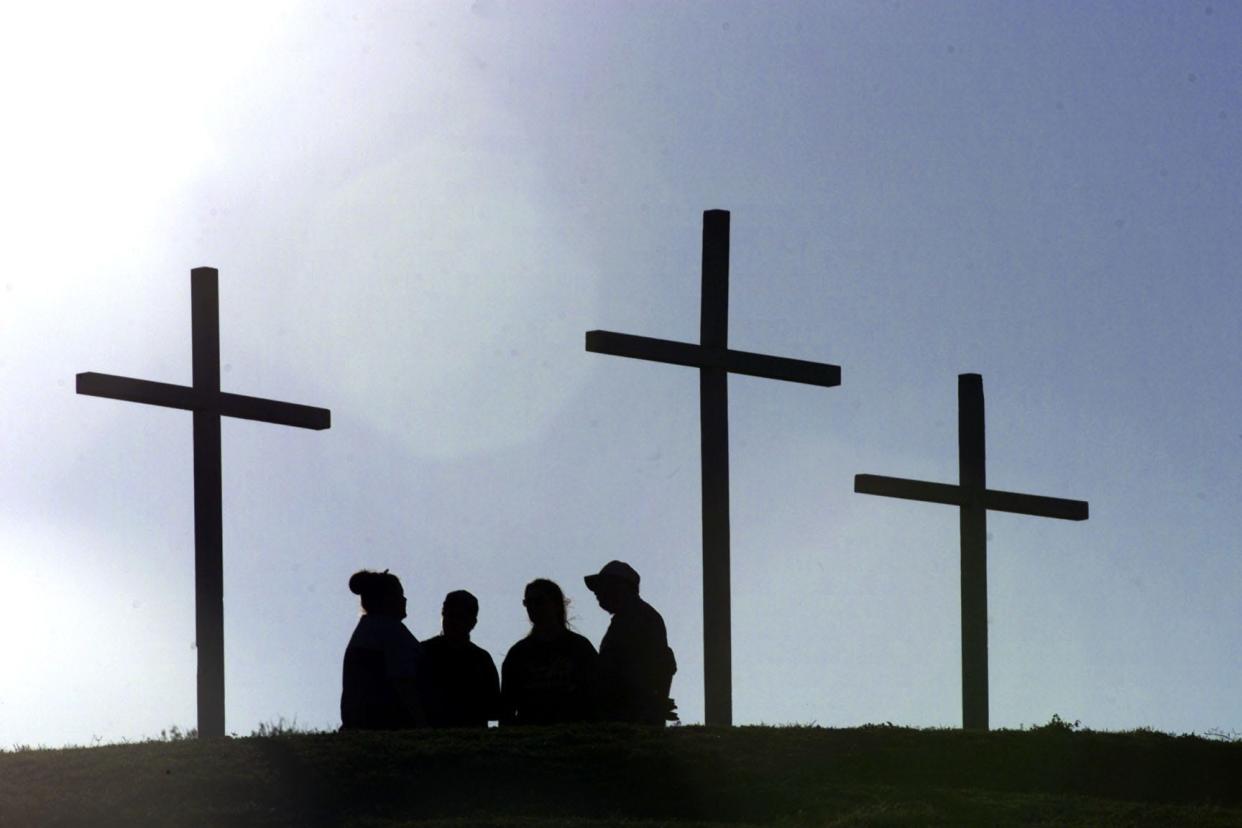 Three crosses are erected at Cole Park in preparation for the Easter Sunrise Passion Play on April 14, 2000.