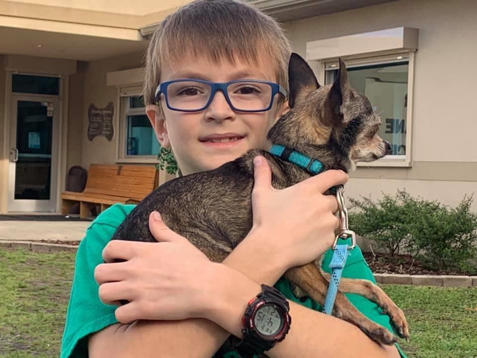 A boy who was inspired by Robbie to adopt a dog. / Credit: Maria Henry Gay