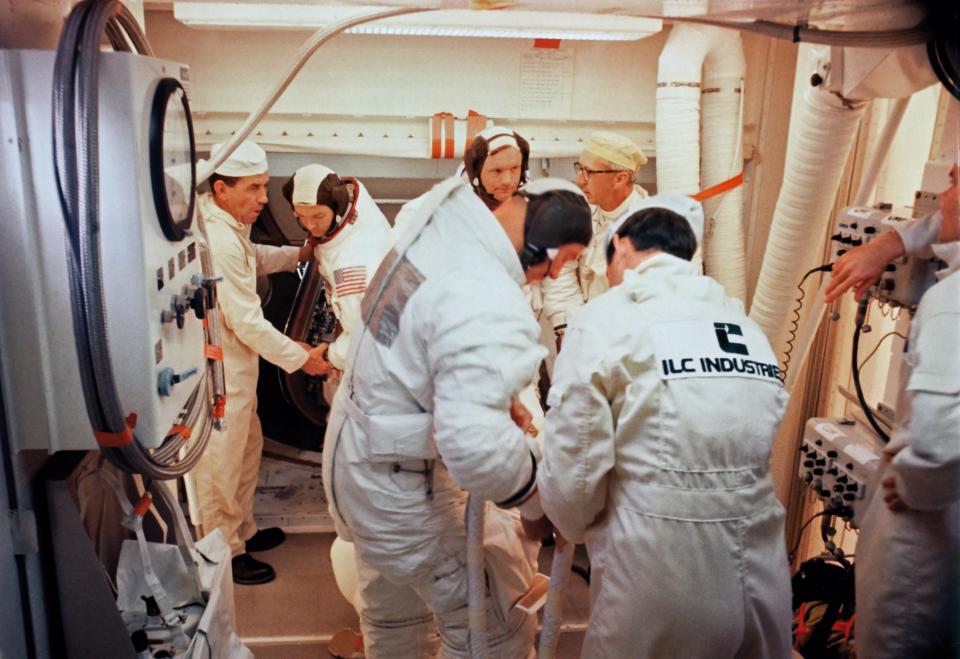 On the Apollo 11 launchpad, Pad leader Guenter Wendt talks with Neil Armstrong. ILC Industries is displayed prominently on Wendt's back.