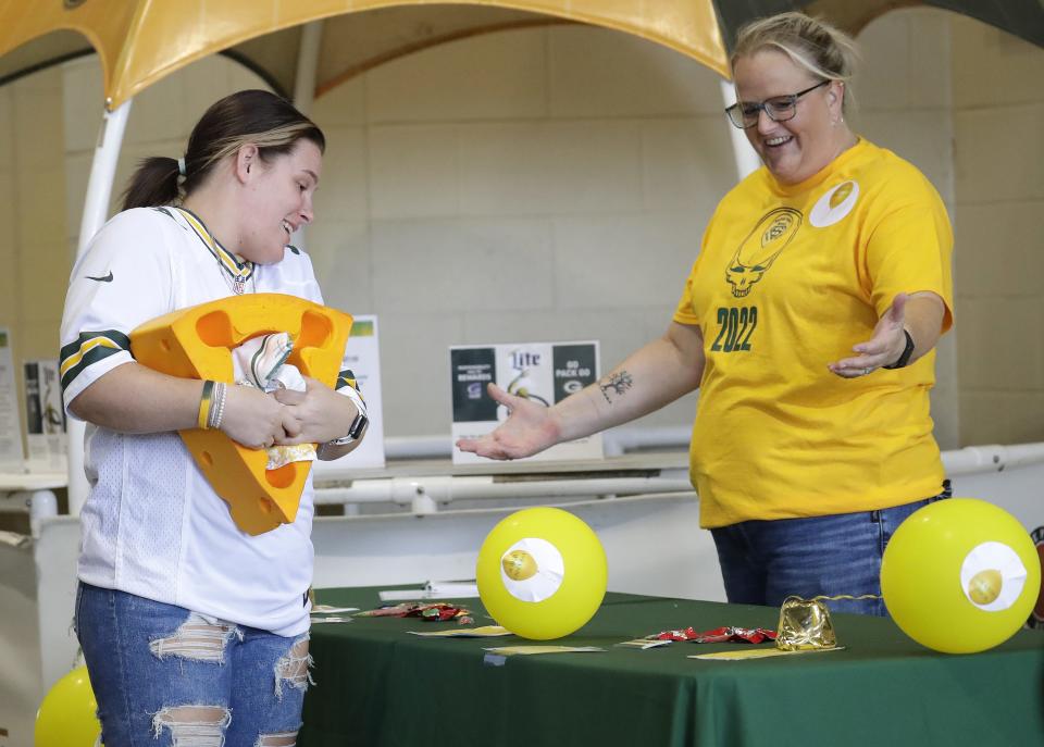 Anisha Murray, left, of Huntersville, Indiana, talks with volunteer Laura Marie John at the Section Yellow table prior to the Packers-Bears game at Lambeau Field. Section Yellow is a Packers fan club that offers a safe space for those who may need sober support on gameday.