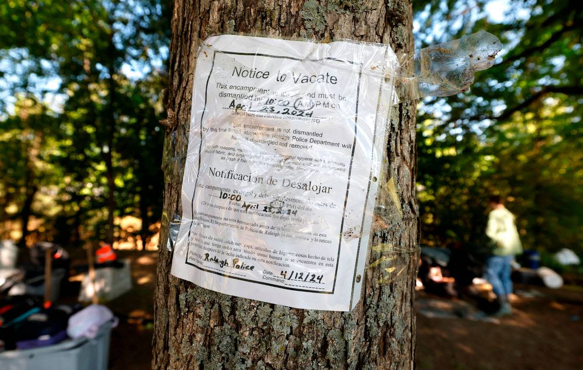 A Notice to Vacate sign is attached to a tree at the “Welcome to Garner” tent community in Garner, N.C., Tuesday, April 23, 2024.
