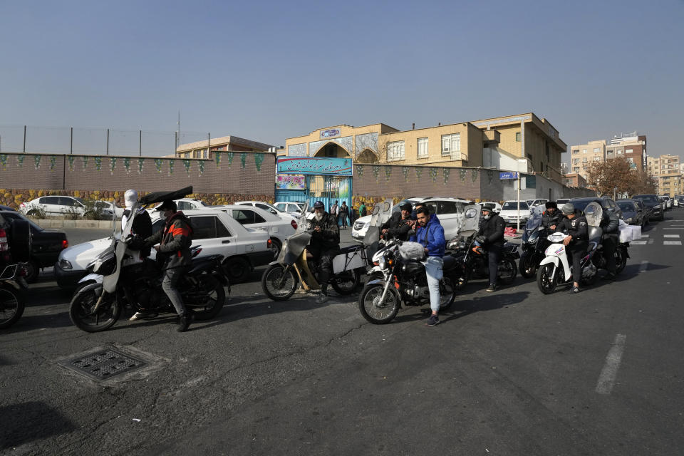 Motorcycles and cars line up outside a gas station in Tehran, Iran, Monday, Dec. 18, 2023. Nearly 70% of Iran's gas stations went out of service on Monday following possible sabotage — a reference to cyberattacks, Iranian state TV reported. (AP Photo/Vahid Salemi)