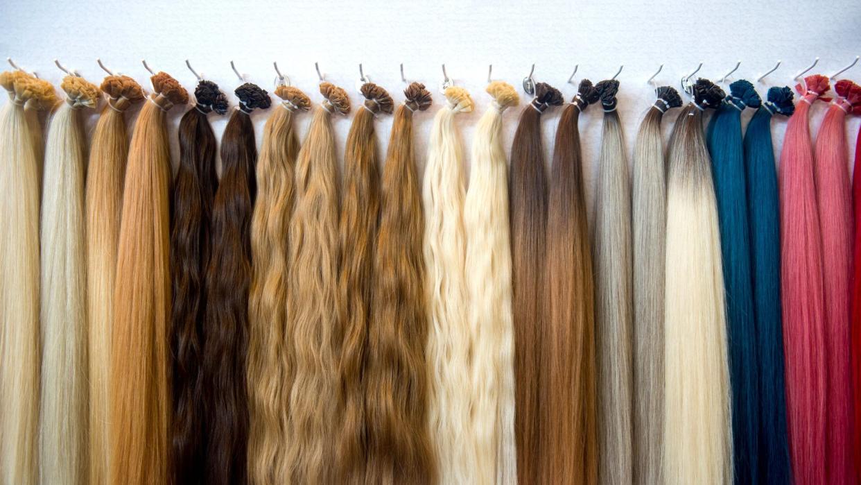 A display of multicolor wigs