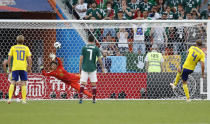 <p>Andreas Granqvist scores an unstoppable penalty past Mexico goalkeeper Guillermo Ochoa </p>