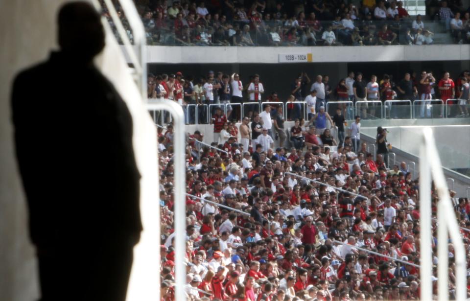 Soccer fans attend the first test event at the Arena da Baixada stadium in Curitiba March 29, 2014. Arena da Baixada is one of the venues for the 2014 World Cup in Brazil. REUTERS/Rodolfo Buhrer (BRAZIL - Tags: SPORT SOCCER WORLD CUP)