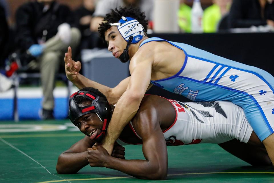 Darius Marines of Detroit Catholic Central, top, celebrates as time expires against Jay'Den Williams of Roseville during Division 1 157 pounds match at MHSAA individual wrestling state finals at Ford Field in Detroit on Saturday, March 2, 2024.