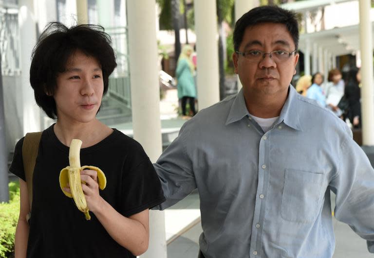 Singaporean student Amos Yee walks alongside his father ahead of a previous court appearance on April 17, 2015