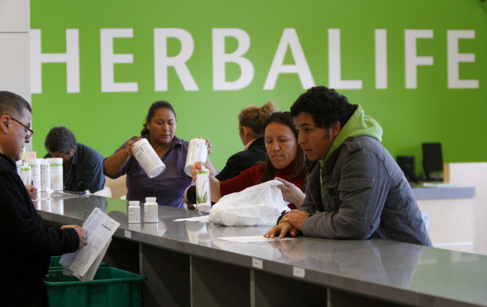 Distributors line-up at the main counter at the Herbalife Distribution Center in Carson, California January 24, 2013. (Photo by Mark Boster/Los Angeles Times via Getty Images)