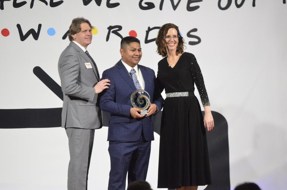 Eric Mejia, Primex Plastics, receives the Young Professional of the Year award from 2024 Chamber Board Chair Ron Holbrook and Chamber President and CEO Melissa Vance during the 2024 Wayne County Area Chamber of Commerce Annual Dinner at First Bank Kuhlman Center, Friday, Jan. 19, 2024.