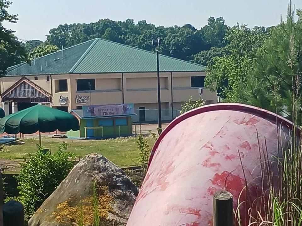 Decorative items lay toppled on the miniature golf course at the closed Queens Landing entertainment complex on Lake Norman in Mooresville on Tuesday, June 27, 2023. Gone are the Catawba Queen and Lady of the Lake dinner cruise boats.