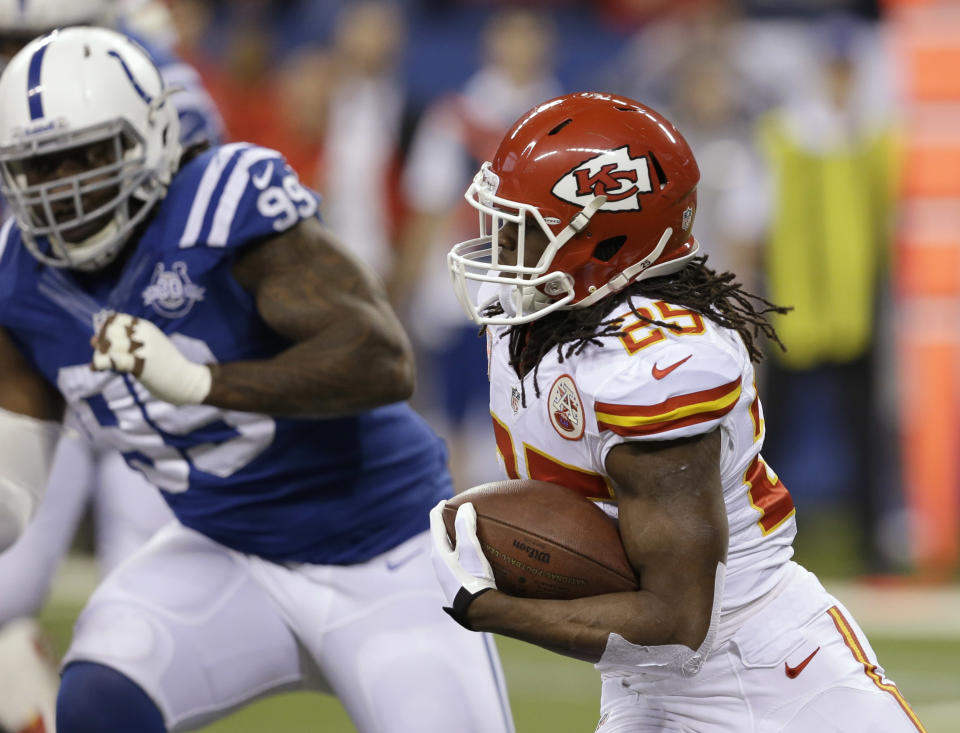 Kansas City Chiefs running back Jamaal Charles (25) runs as Indianapolis Colts defensive end Ricky Jean Francois (99) moves in during the first half of an NFL wild-card playoff football game Saturday, Jan. 4, 2014, in Indianapolis. (AP Photo/Darron Cummings)