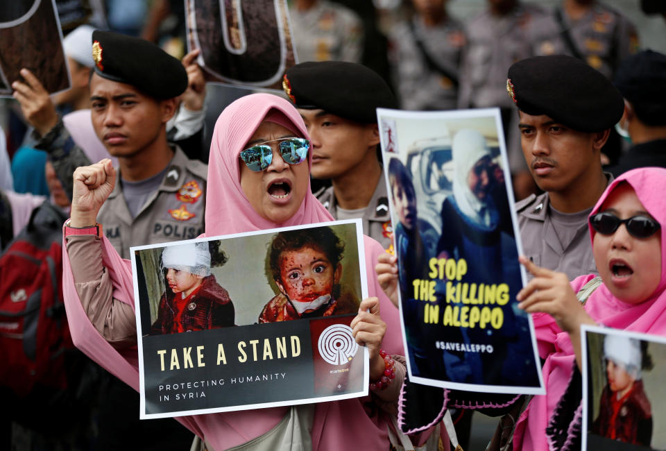 Muslim women hold signs&nbsp;during a protest calling for an end to the violence in Aleppo, Syria outside the Russian embassy in Jakarta, Indonesia, Dec. 19, 2016.