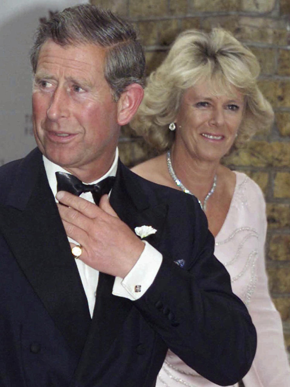 FILE- Britain's Prince Charles arrives with Camilla Parker Bowles attend a charity function in aid of The Prince's Foundation in central London Tuesday, June 20, 2000. (AP Photo/Alastair Grant, File)