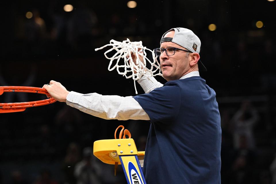 Connecticut Huskies head coach Dan Hurley cuts the net after defeating the Illinois Fighting Illini in the finals of the East Regional of the 2024 NCAA Tournament at TD Garden.