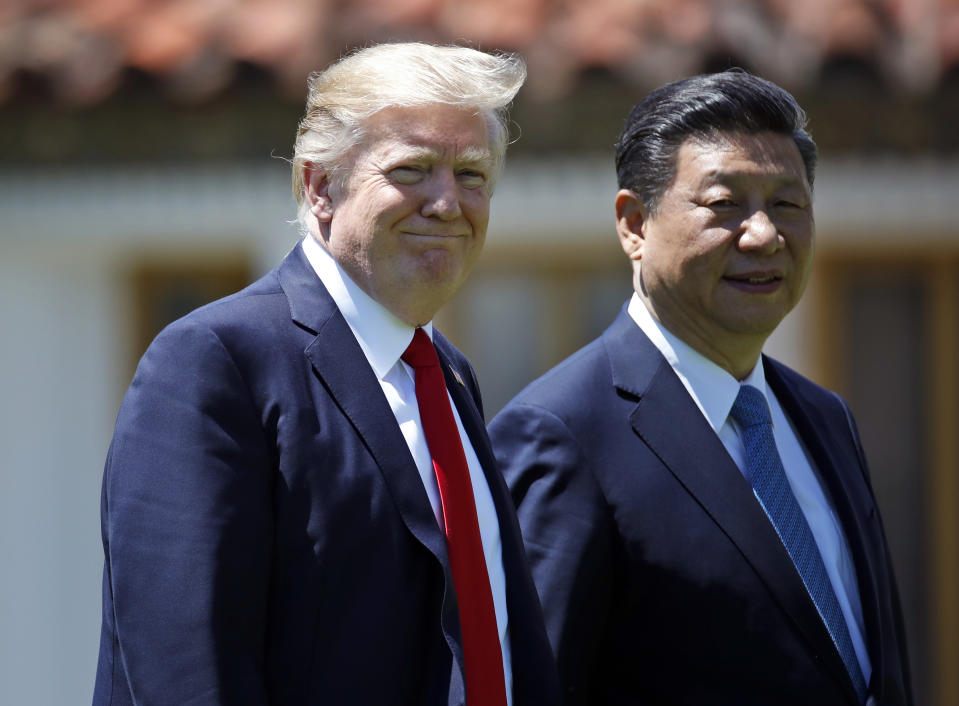 President Donald Trump and Chinese President Xi Jinping walk together after their meetings at Mar-a-Lago, Friday, April 7, 2017, in Palm Beach, Fla. Trump was meeting again with his Chinese counterpart Friday, with U.S. missile strikes on Syria adding weight to his threat to act unilaterally against the nuclear weapons program of China's ally, North Korea. (AP Photo/Alex Brandon)