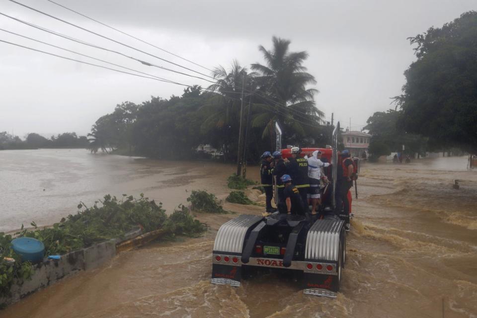 Members of the Rescue Police drive in a flooded street after the passage of hurricane Fiona, in Toa Baja, Puerto Rico, 19 September 2022. (EPA)