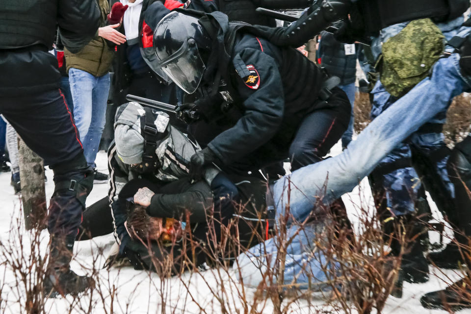 Riot police detain a demonstrator with a bloody face during a protest against the jailing of opposition leader Alexei Navalny in Pushkin square in Moscow, Russia, Saturday, Jan. 23, 2021. Russian police arrested more than 3,400 people Saturday in nationwide protests demanding the release of opposition leader Alexei Navalny, the Kremlin's most prominent foe, according to a group that counts political detentions. In Moscow, an estimated 15,000 demonstrators gathered in and around Pushkin Square in the city center, where clashes with police broke out and demonstrators were roughly dragged off by helmeted riot officers to police buses and detention trucks. Some were beaten with batons. (AP Photo/Alexander Zemlianichenko)