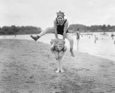 <p>Two young women donning swim caps and bathing suits play leapfrog on the beach.</p><p>Related: <a href="https://www.esquire.com/lifestyle/g15897154/celebrity-beach-photos-vintage/" rel="nofollow noopener" target="_blank" data-ylk="slk:Vintage Photos of Celebrities at the Beach;elm:context_link;itc:0;sec:content-canvas" class="link ">Vintage Photos of Celebrities at the Beach</a></p>