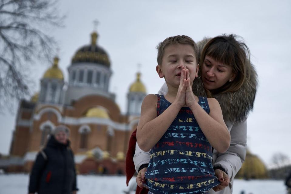 A woman helps prepare her child to plunge into icy water to celebrate Epiphany in Kyiv, Ukraine, on Jan. 6, 2024. (Kostiantyn Liberov/Libkos/Getty Images)