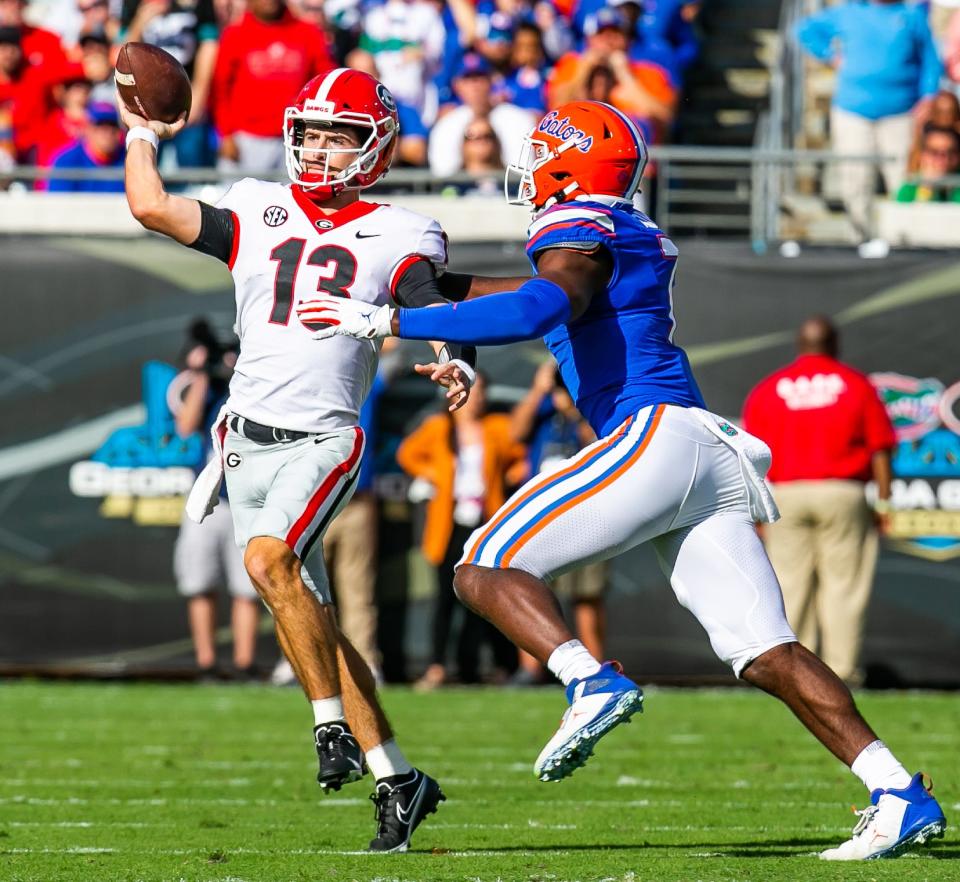 Florida Gators linebacker Jeremiah Moon (7) pressures Georgia Bulldogs quarterback Stetson Bennett (13). The Florida Gators played the Georgia Bulldogs in the first half Saturday afternoon, October 30, 2021 at TIAA Bank Field in Jacksonville, FL. [Doug Engle/Gainesville Sun]2021